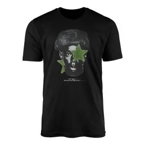 Black crewneck t-shirt flat lay showing a high-contrast monochrome portrait with a green star over one eye
