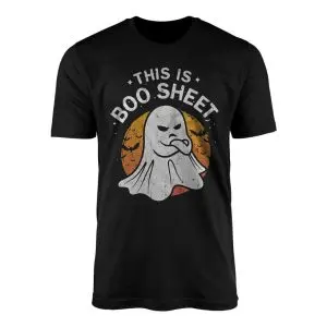 Black crewneck t-shirt flat lay showing a grumpy sheet ghost over an orange moon with This Is Boo Sheet text
