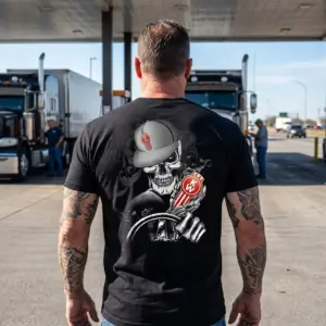 Badass Skeleton Trucker with Kenworth Logo T-Shirt 10 Skeleton Trucker T-Shirt design, embodying the open road lifestyle with a skull in a cap gripping a steering wheel and Kenworth logo.