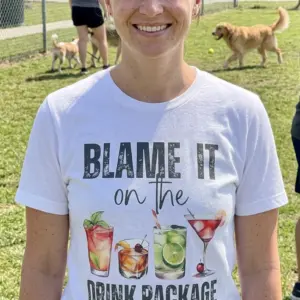 Blame It On The Drink Package Funny Cocktail T-Shirt 11 Person wearing black T-shirt with cocktail illustrations in a casual setting.