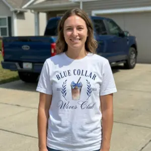 Blue Collar Wives Club Iced Coffee T-Shirt 11 Person wearing 'Blue Collar Wives Club' T-shirt with iced coffee logo in casual setting.