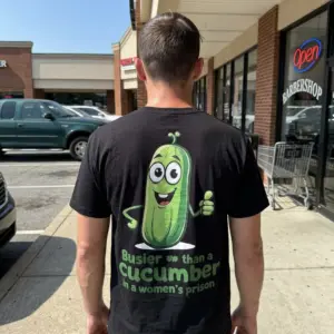 Busier Than A Cucumber Funny Adult T-Shirt 11 Person wearing a t-shirt with a funny cucumber design in a casual setting.