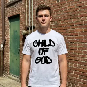 Child of God Christian Streetwear Graphic T-Shirt 11 Model wearing a white t-shirt with 'Child of God' graphic, styled for streetwear.