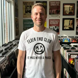 Elder Emo Club It Was Never A Phase T-Shirt 11 Person wearing 'Elder Emo Club' T-shirt with text and smiley, in a casual setting.