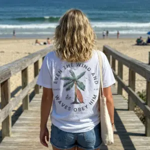 Even The Wind And Waves Obey Him Surf T-Shirt 11 Person wearing the Christian Surf Shirt in a casual setting, showcasing the design.