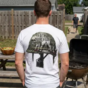 Faith Over Fear Military Helmet Skull T-Shirt 11 Model wearing T-shirt with 'Faith Over Fear' military helmet design, outdoors.
