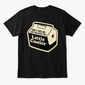 Front flat lay of a black t-shirt featuring a vintage drink cooler graphic with the text Don't Hate Me Just Because I'm a Little Cooler.