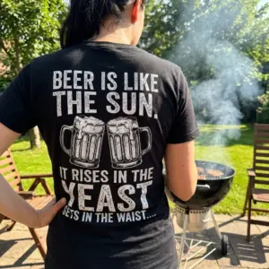 Funny Beer Is Like The Sun Graphic T-Shirt 11 Close-up of the back of a black t-shirt worn by a man, featuring a humorous beer pun graphic with clinking mugs.