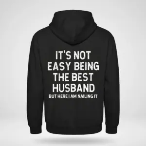 Funny Best Husband Ever T-Shirt 7 Back flat lay of a hoodie featuring the quote It's Not Easy Being The Best Husband But Here I Am Nailing It.
