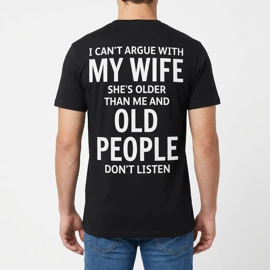 Funny Can't Argue With My Wife Husband Shirt 4 Back view of a man wearing the black funny husband shirt with the text: "I can't argue with my wife she's older than me and old people don't listen.