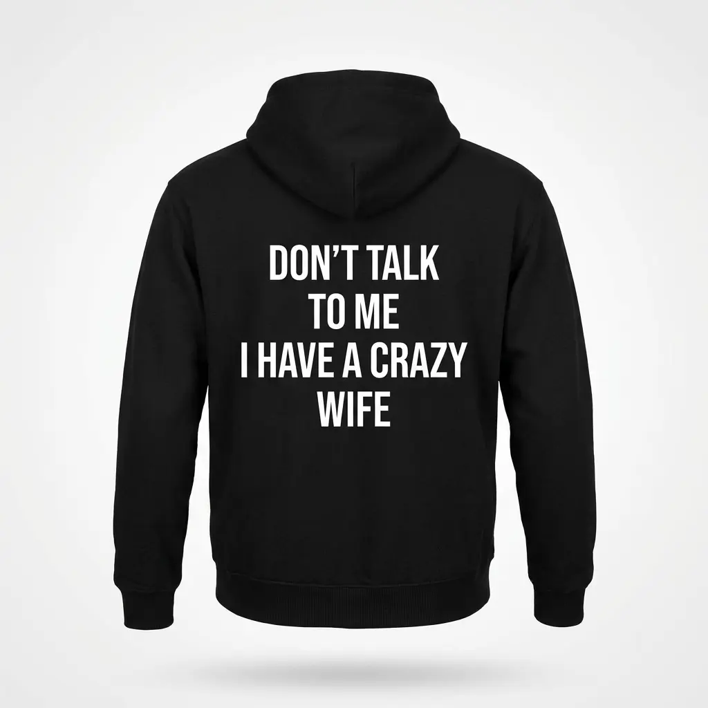 Back flat lay of a black hoodie featuring the Don't Talk to Me I Have a Crazy Wife humorous text design.