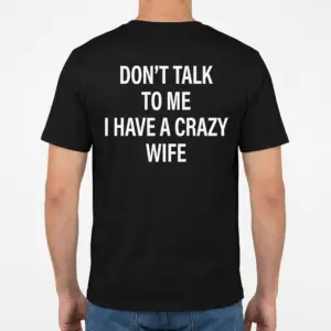 Funny Crazy Wife Husband T-Shirt 9 Back view of a man wearing a black t-shirt printed with Don't Talk to Me I Have a Crazy Wife.