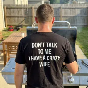 Funny Crazy Wife Husband T-Shirt 10 Lifestyle view of the back of a black t-shirt reading Don't Talk to Me I Have a Crazy Wife.