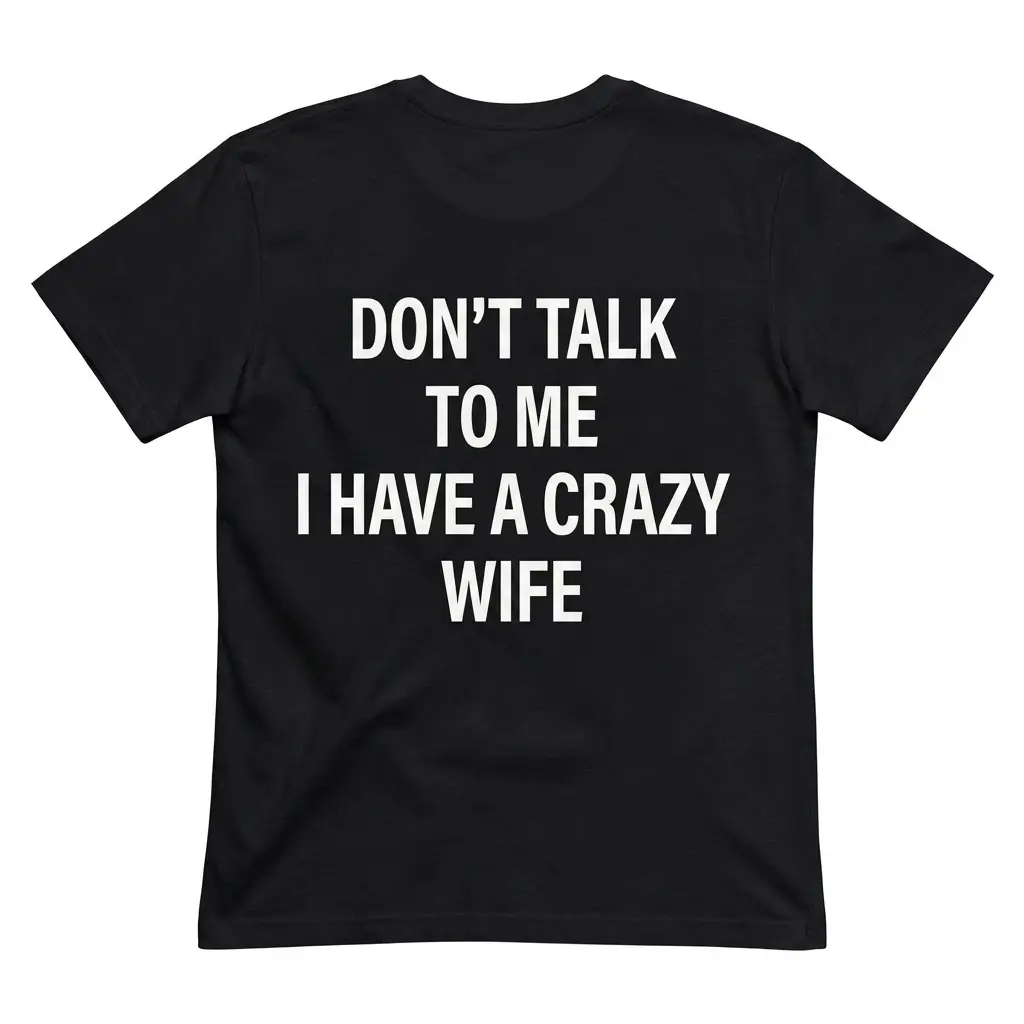 Back flat lay of a black t-shirt reading Don't Talk to Me I Have a Crazy Wife in bold white text.