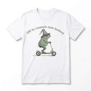 White frog scooter shirt flat lay showing a green toad in a purple wizard hat riding a kick scooter