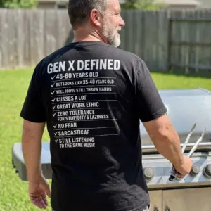Funny Gen X Defined Checklist Graphic T-Shirt 10 Man outdoors wearing the black t-shirt featuring the funny Gen X Defined graphic on the back.