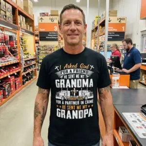 Funny God Sent Me My Grandma & Grandpa T-Shirt 10 Black t-shirt showcasing the "I Asked God FOR A FRIEND... GRANDMA" and "FOR A PARTNER IN CRIME... GRANDPA" text with semi-trucks.