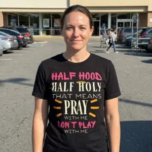 Funny Half Hood Half Holy Christian T-Shirt 11 Person wearing black T-shirt with 'Half Hood Half Holy' graphic design.