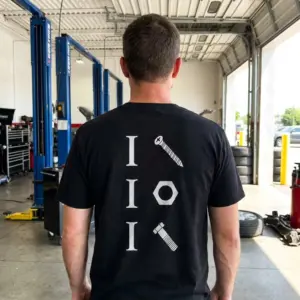 Funny Hardware Pun Mechanic T-Shirt 10 A man wearing the black funny mechanic shirt in a casual setting, showcasing the suggestive hardware pun graphic printed on the back.