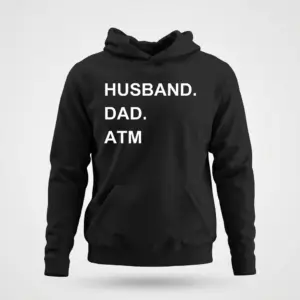 Funny Husband Dad ATM Graphic T-Shirt 7 Front flat lay of a black hoodie featuring the humorous white text 'HUSBAND. DAD. ATM' across the chest.