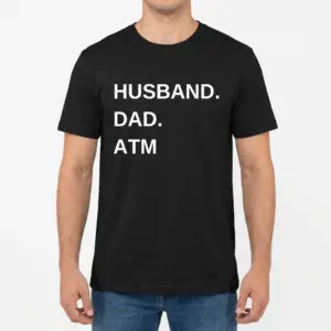 Funny Husband Dad ATM Graphic T-Shirt 9 Front view of a man modeling the black t-shirt printed with 'HUSBAND. DAD. ATM'.