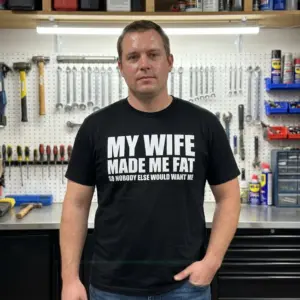 Funny My Wife Made Me Fat T-Shirt 11 Casual lifestyle display highlighting the My Wife Made Me Fat funny husband apparel design.