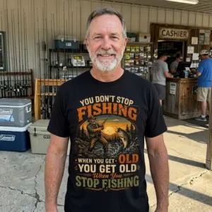 Funny Old Fisherman Never Stop Fishing T-Shirt 10 The black t-shirt featuring the funny "Never Stop Fishing" design, ideal for celebrating the passion of older fishermen.