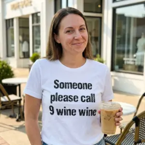 Funny Someone Please Call 9 Wine Wine T-Shirt 11 Lifestyle shot highlighting the funny call 9 wine wine graphic design on a casual garment.