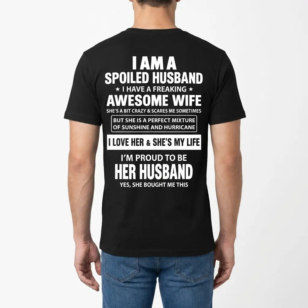 Rear view of a man wearing the black spoiled husband t-shirt showcasing the full white text on the back.
