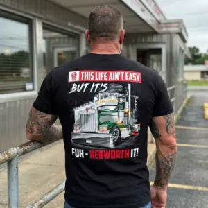 Funny Trucker Kenworth Life T-Shirt 11 The "This Life Ain't Easy But It's Fuh-Kenworth It!" Kenworth design prominently featured on a black garment in a lifestyle shot.