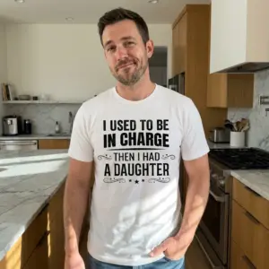 Funny Used To Be In Charge Daughter T-Shirt 10 Lifestyle shot showing the funny girl dad shirt with I Used To Be In Charge Then I Had A Daughter.
