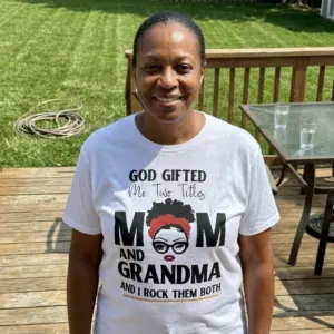 God Gifted Me Two Titles Mom and Grandma T-Shirt 11 Person wearing T-shirt with 'God Gifted Me Two Titles Mom and Grandma' design, showing casual style.