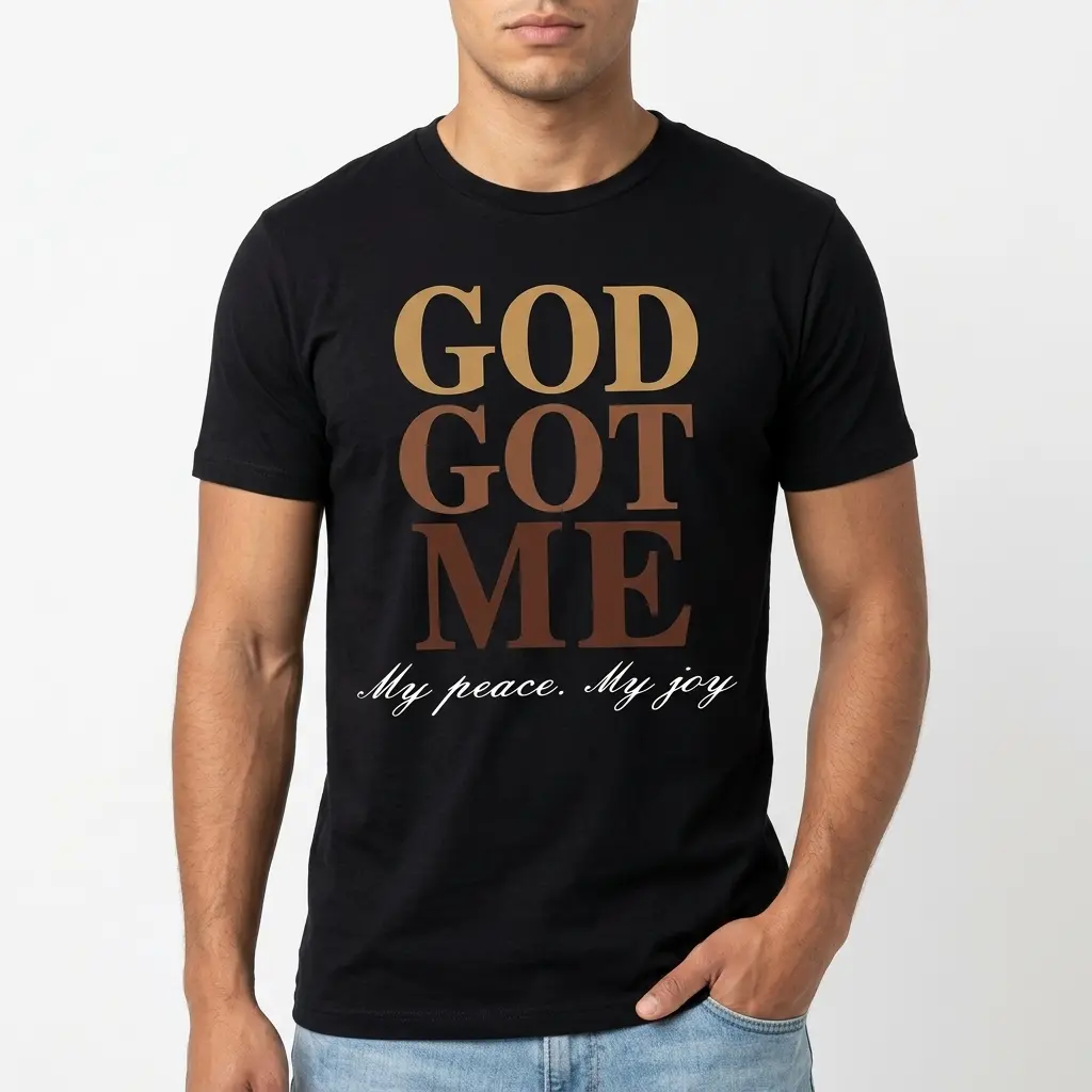 Close-up of 'God Got Me, My Peace, My Joy' text on T-shirt.