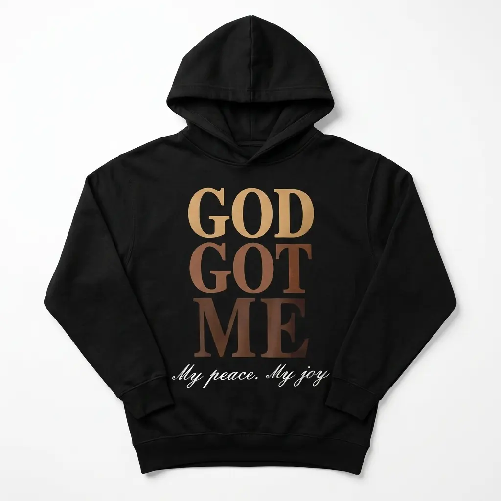 Close-up of 'God Got Me' text on black shirt.