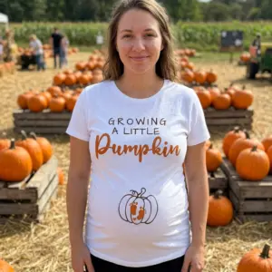 Growing A Little Pumpkin Pregnancy Announcement Shirt 11 White shirt with fall-themed pregnancy announcement in lifestyle setting.