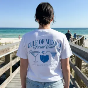 Gulf of Mexico Social Club Beach T-Shirt 11 Person wearing Gulf of Mexico Social Club T-shirt by the beach.