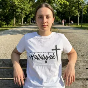 Hard Fought Hallelujah Christian Faith T-Shirt 11 Person wearing a Christian t-shirt with a black cross and 'Hallelujah' text.