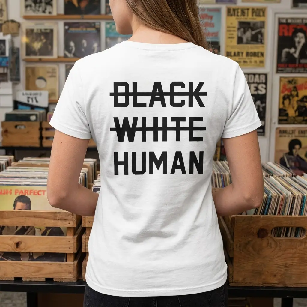 Lifestyle view showing the back of the apparel printed with crossed-out BLACK and WHITE text above the word HUMAN.