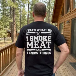 I Smoke Meat and I Know Things BBQ T-Shirt 11 Close-up back view of a person wearing the funny BBQ shirt featuring the white text "That's What I Do I Smoke Meat And I Know Things".