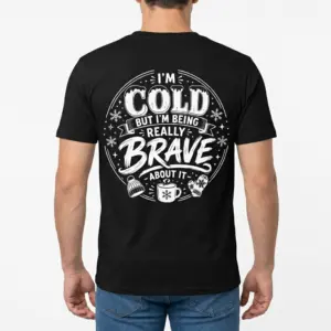 I'm Cold But Really Brave Winter Sarcastic T-Shirt 9 Back view of a man wearing a black t-shirt that features the "I'M COLD BUT I'M BEING REALLY BRAVE ABOUT IT" winter joke design.