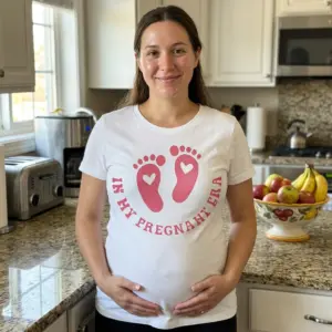 In My Pregnant Era Footprint T-Shirt 11 Person wearing t-shirt with pink footprint and 'In My Pregnant Era' message.