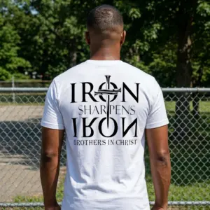 Iron Sharpens Iron Christian Brotherhood T-Shirt 11 Model wearing the 'Iron Sharpens Iron' t-shirt outdoors, emphasizing its casual style.