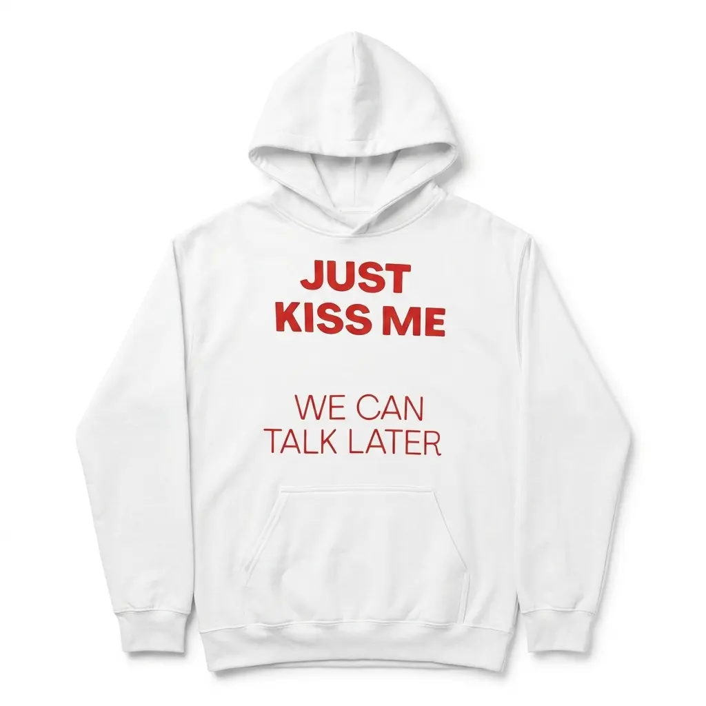 T-shirt flat lay displaying graphic text 'Just Kiss Me We Can Talk Later' in red.