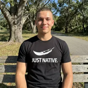 Just Native Feather Graphic T-Shirt 11 Model wearing the black Native feather shirt paired with casual jeans.