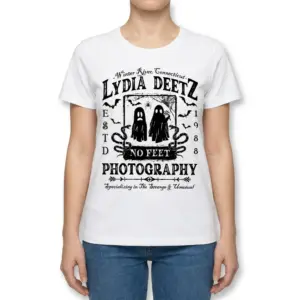 Lydia Deetz Photography Strange & Unusual Tee 9 Woman facing front, wearing a white t-shirt with the 'Lydia Deetz No Feet Photography' vintage gothic design.
