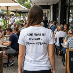 Memories And Mistakes Funny Quote T-Shirt 10 Lifestyle view showcasing the back of the Memories and Mistakes graphic shirt worn in an everyday setting.