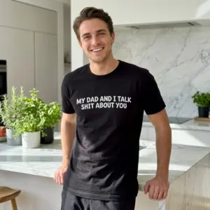 My Dad And I Talk Funny Sarcastic T-Shirt 11 Casual lifestyle setting highlighting the humorous My Dad And I Talk Shit About You black shirt design.