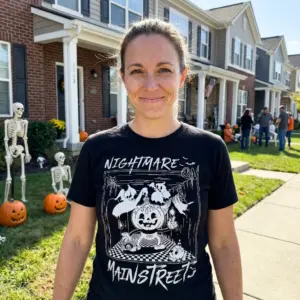 Nightmare Main Street Halloween Tee 11 Casual image featuring the Nightmare Main Street T-Shirt, styled in a cozy Halloween-themed setting.