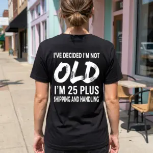 Not Old 25 Plus Shipping and Handling T-Shirt 10 A man wearing the black funny birthday shirt in a casual outdoor setting, showing the graphic text on the back.