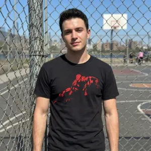 Retro Abstract Spider-Man Comic Fan T-Shirt 10 Person in a vivid urban setting wearing abstract red web-slinging hero T-shirt.